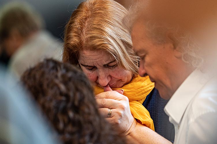 Eine Frau und ein Mann beten in einer Gebetsgruppe für verfolgte Christen