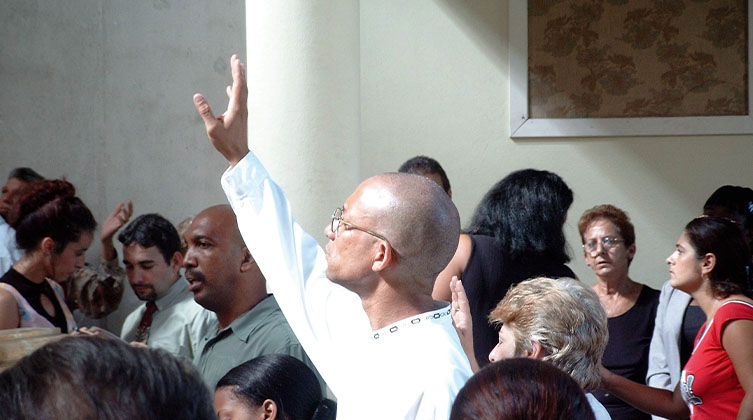 Ein Mann steht inmitten einer Menschenmenge und gebt seinen rechten Arm