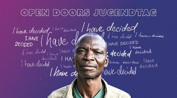 Ein Mann guckt entschlossen in die Kamera. Hinter ihm steht auf einem lilablauen Farbverlauf geschrieben: I have decided. Darüber der Titel Open Doors Jugendtag.