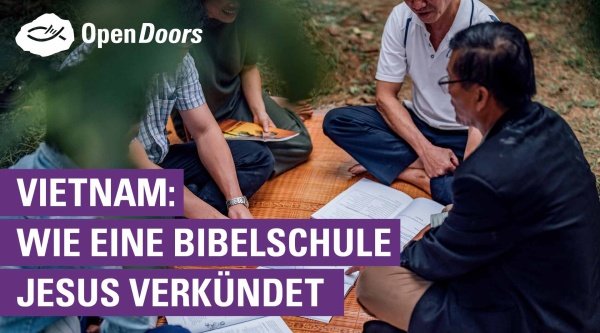 Eine Gruppe Vietnamesen sitzt auf einer Decke und liest in der Bibel