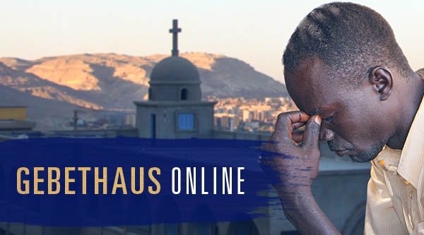 Ein Mann stützt seinen Kopf auf seine Hand im Hintergrund eine Kirche