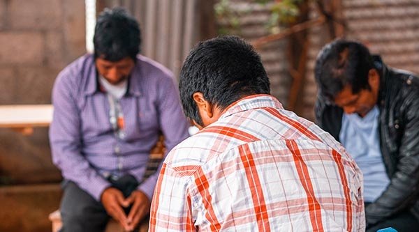 Drei Männer beten gemeinsam