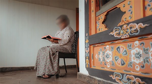 Eine Frau sitzt in einem Raum und liest