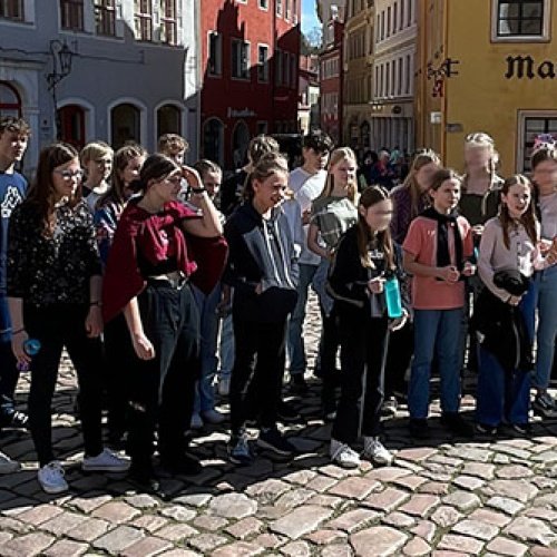 Eine Gruppe Jugendliche steht auf einem Markt zusammen