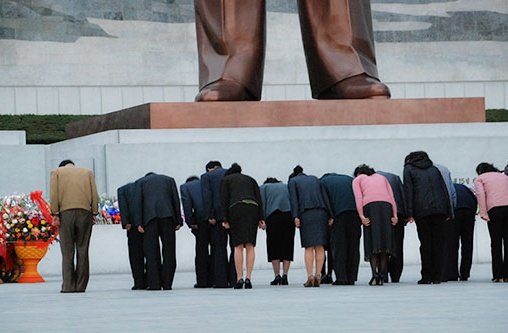 Nordkoreaner verbeugen sich vor einer Statue