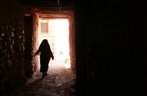 Eine Frau läuft aus einem dunklen Raum nach draußen ins Freie